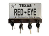 Key hanger shown against white background. A license plate is prominently displayed by the key holder. The license plate reads "RED EYE". Four pegs across the bottom hold keys. Key hanger is a dark walnut color.